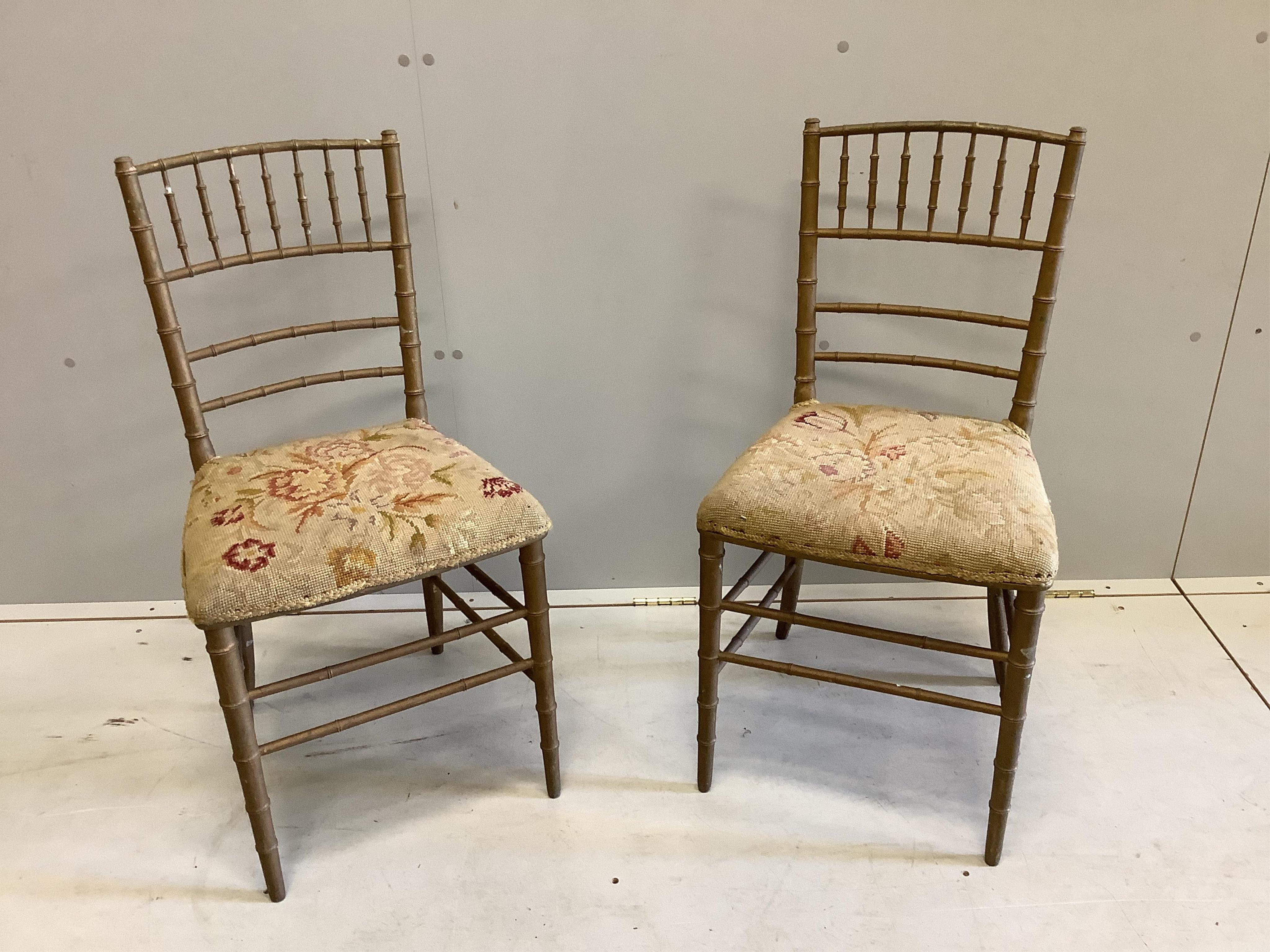 A pair of early 20th century gold painted faux bamboo tapestry seat ballroom chairs, height 83cm. Condition - poor